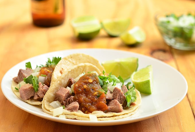 Lengua tacos with tongue, cilantro, onions, salsa roja in warm tortillas