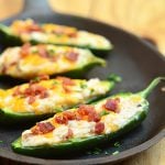 Jalapeno Poppers are stuffed with a mixture of cream cheese, shredded cheddar, and crumbled bacon and then baked until gooey and bubbly. Creamy and spicy, they're like a party in your mouth!