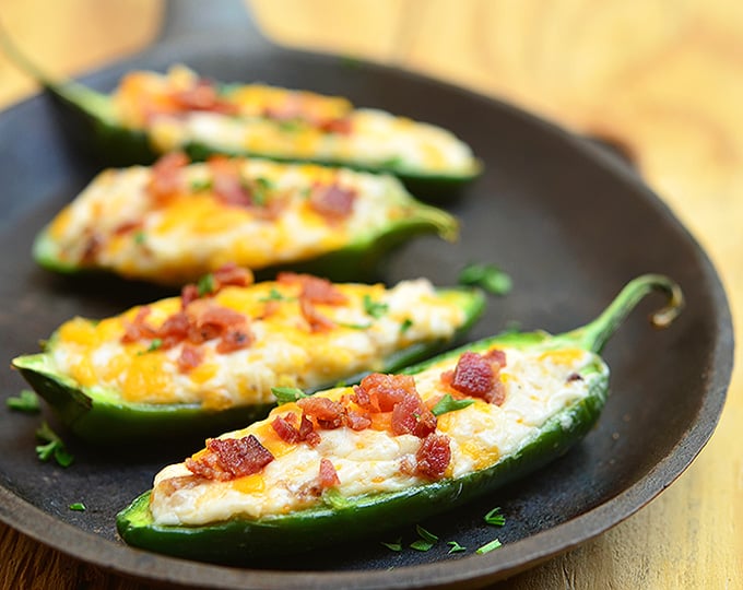 Jalapeno Poppers are stuffed with a mixture of cream cheese, shredded cheddar, and crumbled bacon and then baked until gooey and bubbly. Creamy and spicy, they're like a party in your mouth!