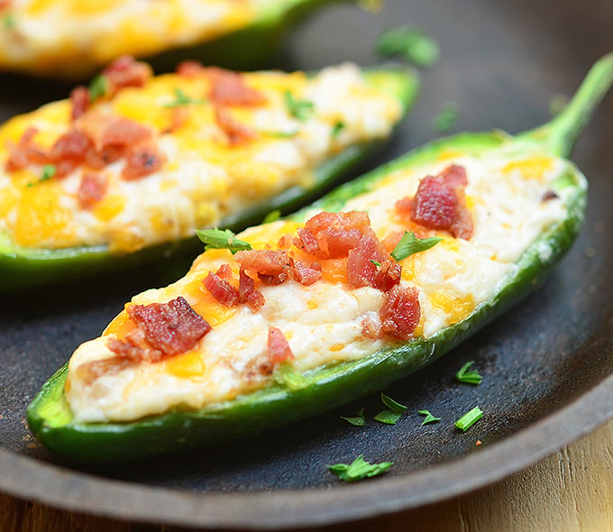 Jalapeno Poppers are stuffed with a mixture of cream cheese, shredded cheddar, and crumbled bacon and then baked until gooey and bubbly. Creamy and spicy, they're like a party in your mouth!
