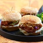 Slow Cooker Root Beer Pulled Pork Sliders made of moist slow cooker pulled pork and tangy coleslaw in slider buns. With loads of flavor and in fun size, they're perfect for tailgating!