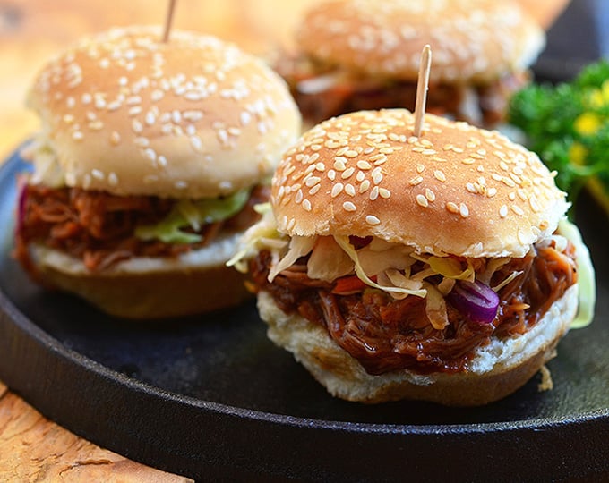 These sliders have it all: slow cooker root beer pulled pork, crisp homemade coleslaw, and fun-size buns!