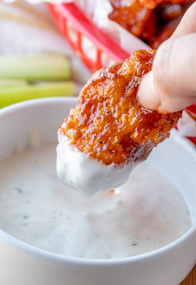 dipping cajun buffalo chicken in ranch dressing