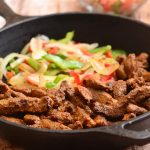 Skillet Beef Fajitas with sirloin, bell peppers, and onions marinated in lime and seasonings and seared to tender perfection. Serve with warm tortillas and your favorite fixings for an amazing Mexican feast!