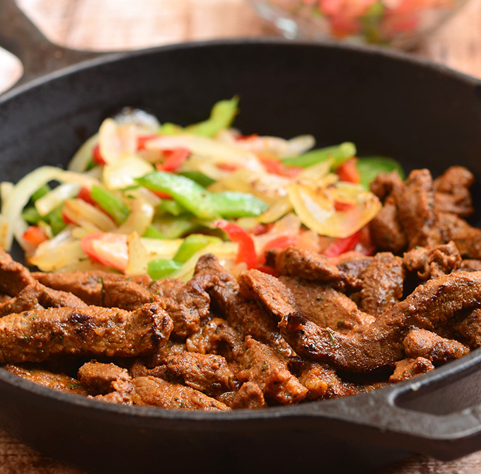 Skillet Beef Fajitas with sirloin, bell peppers, and onions marinated in lime and seasonings and seared to tender perfection. Serve with warm tortillas and your favorite fixings for an amazing Mexican feast!