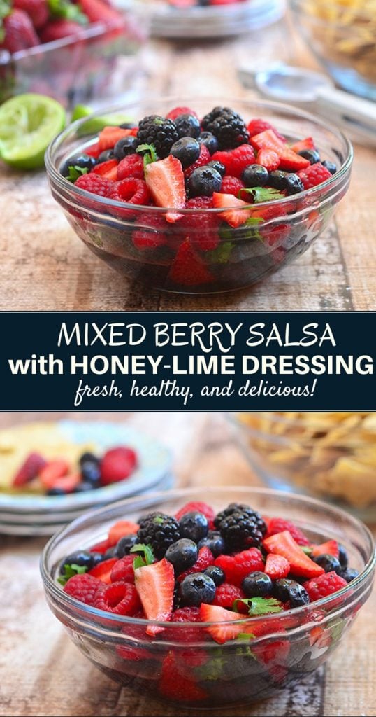 berry salsa with blueberries, blackeberries, strawberries and raspberries in a clear serving bowl with a side of tortilla chips