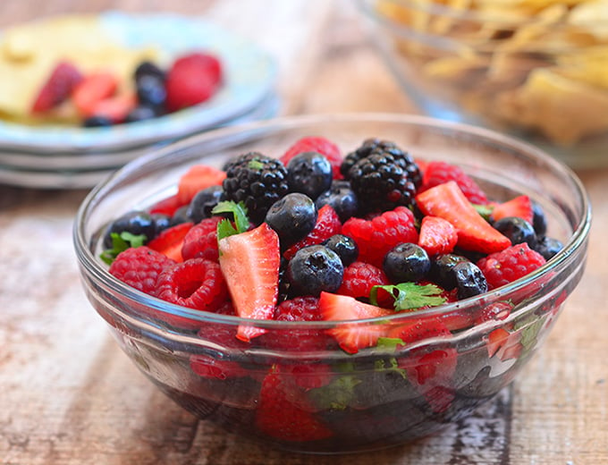 mixed berry salsa with cilantro in a clear serving bowl