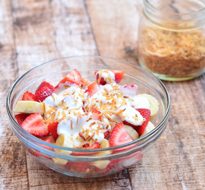 Strawberry Banana and Cream Salad with strawberries. bananas, sour cream dressing, and toasted coconut. Sweet and creamy, it's a healthy and delicious addition to any summer potluck!