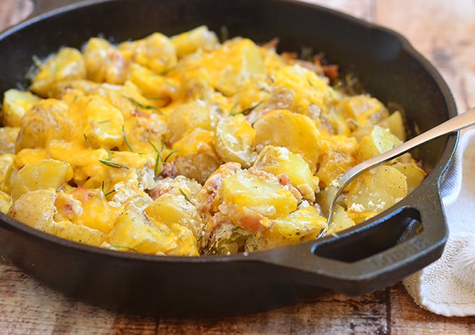 Cheesy Potato Casserole with sour cream sauce, crisp bacon, and fresh rosemary is the ultimate side dish. It's hearty and delicious!