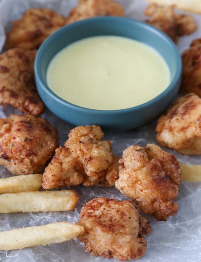 Crispy Popcorn Chicken with a bowl of honey mustard dipping