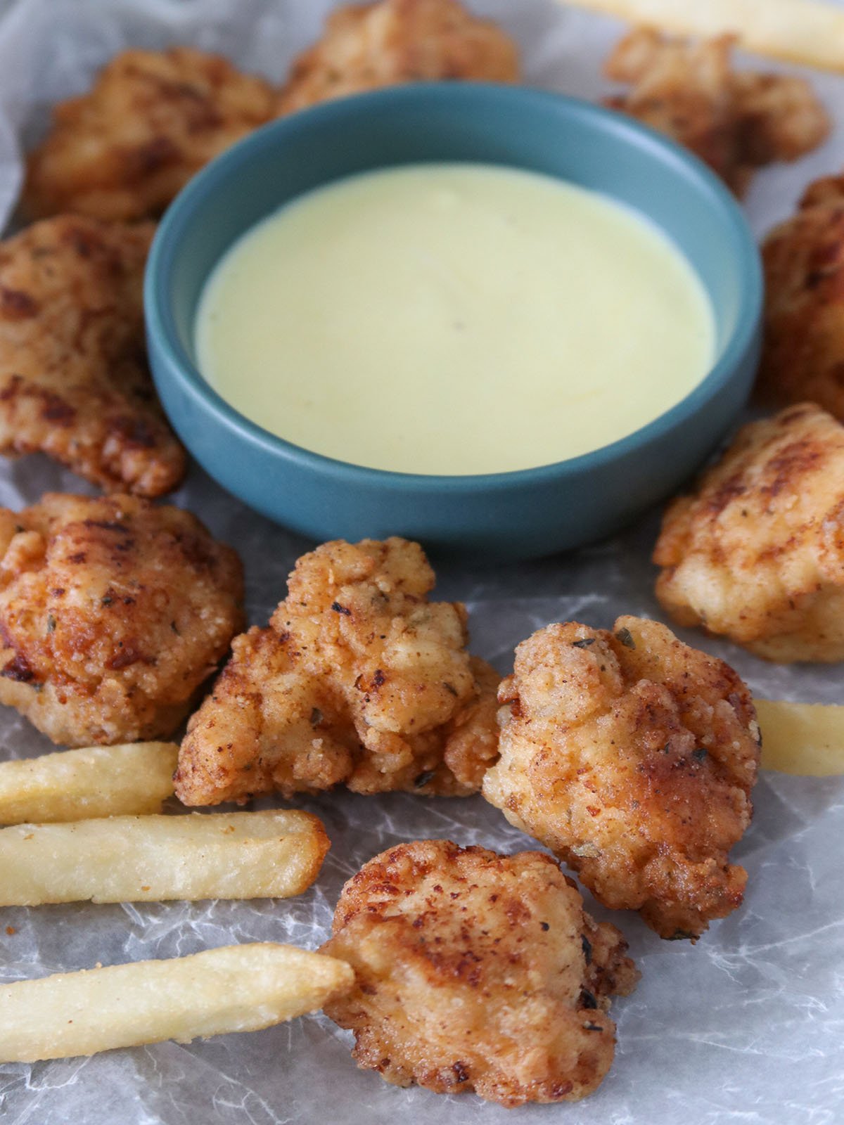 Crispy Popcorn Chicken with a bowl of honey mustard dipping