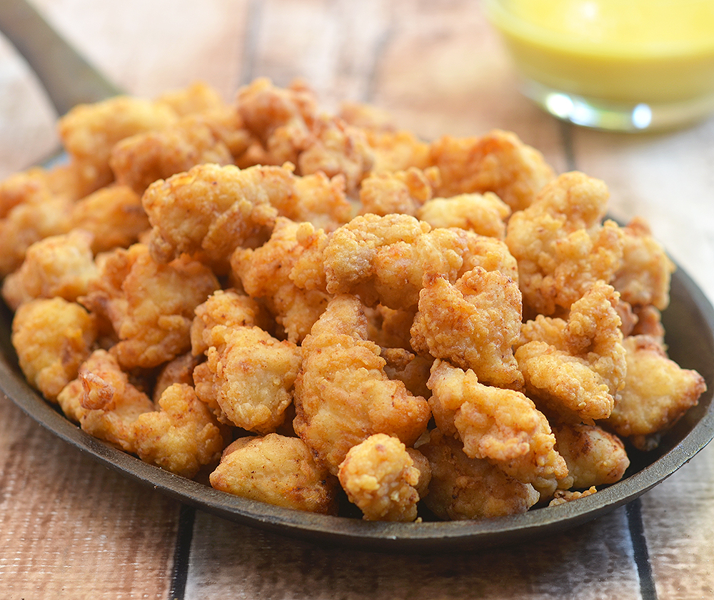 Popcorn Chicken made with a secret ingredient for super light and crisp texture. Served with honey mustard or your choice of dipping sauce, they're absolutely addicting!
