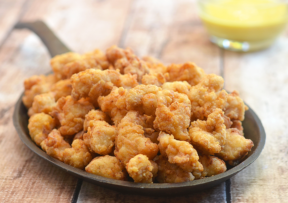 Popcorn Chicken made with a secret ingredient for super light and crisp texture. Served with honey mustard or your choice of dipping sauce, they're absolutely addicting!