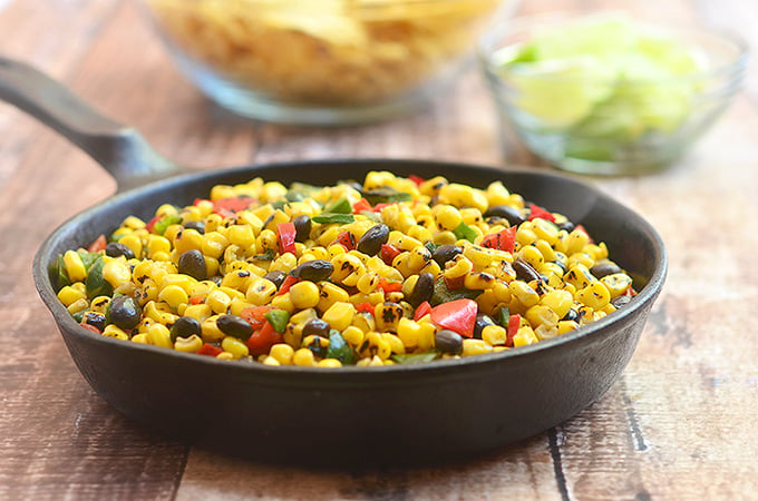 Roasted Corn and Black Bean Salad bursting with the smoky flavors of grilled corn, poblano peppers; and black beans. Delicious as a dip for tortilla chips yet just as awesome as a vegetarian filling for enchiladas or quesadillas.