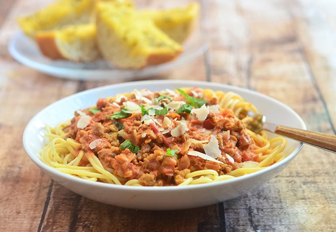 Spaghetti with Italian Sausage and Vodka Sauce on a plate with garlic bread on the side