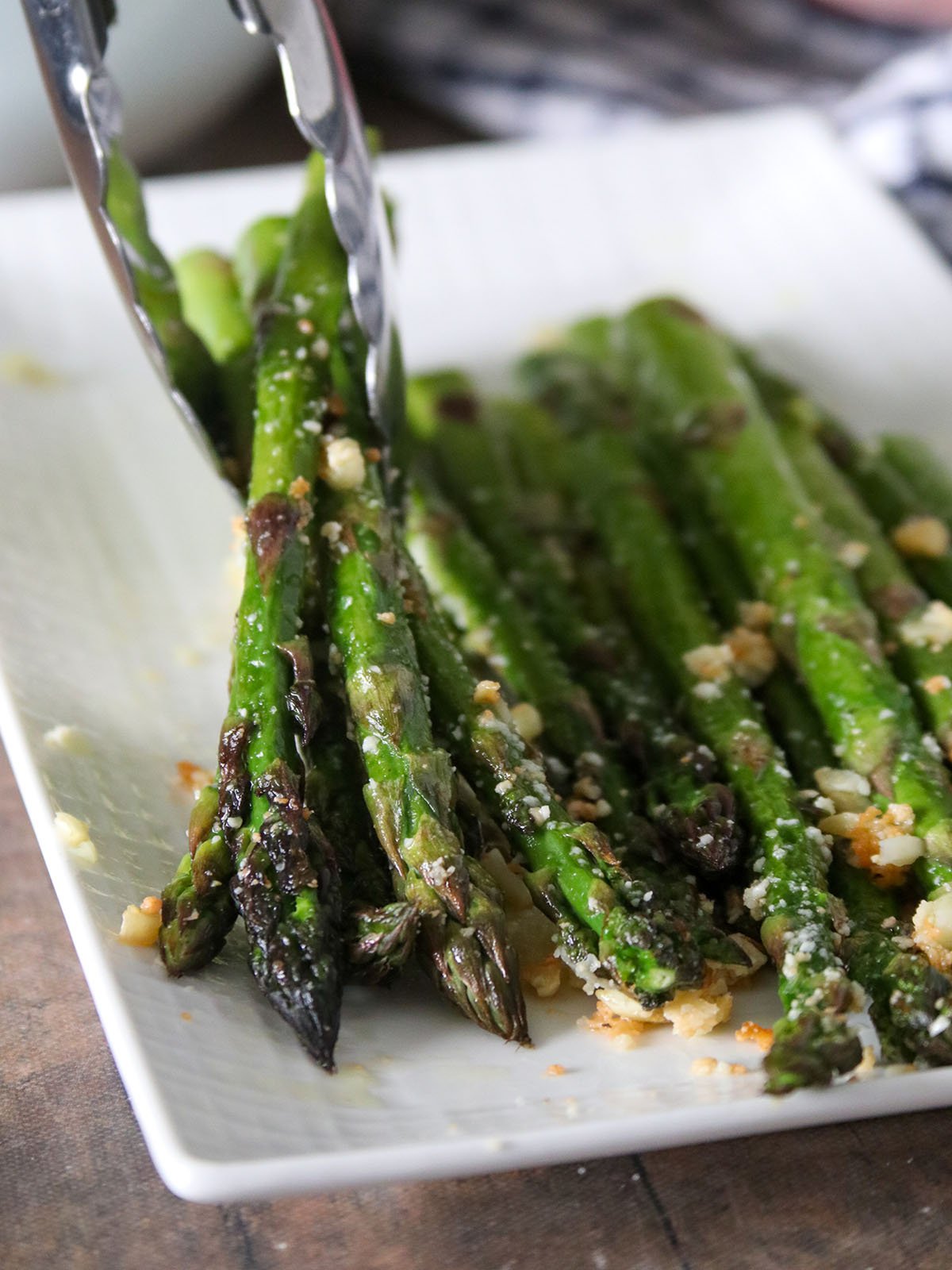 serving roasted asparagus with tongs