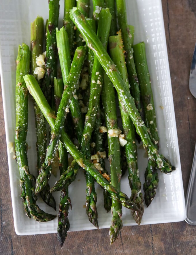 Garlic Parmesan Roasted Asparagus on a white platter