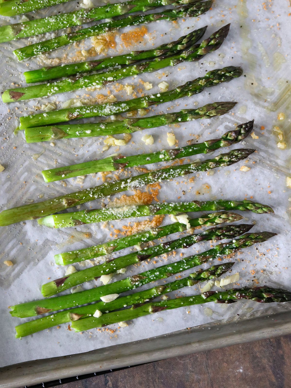 roasted asparagus with garlic and parmesan cheese on a baking sheet