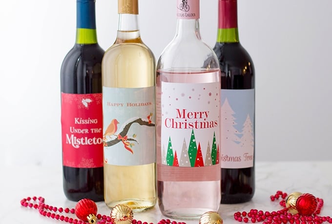 four bottles of wine with Christmas labels