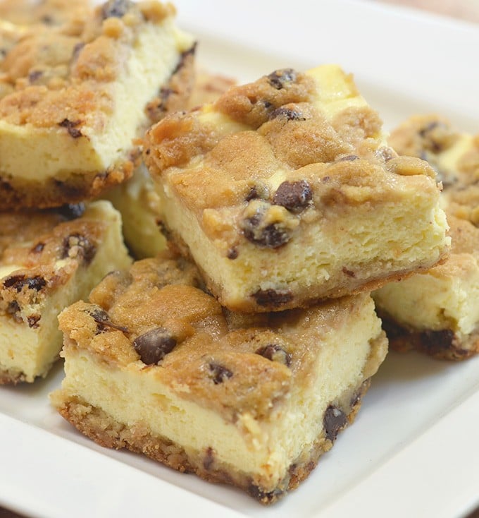 Chocolate Chip Cookie Cheesecake bars with creamy cheesecake filling sandwiched between chewy chocolate chip cookie layers. They're a delicious marriage of two all time favorites!