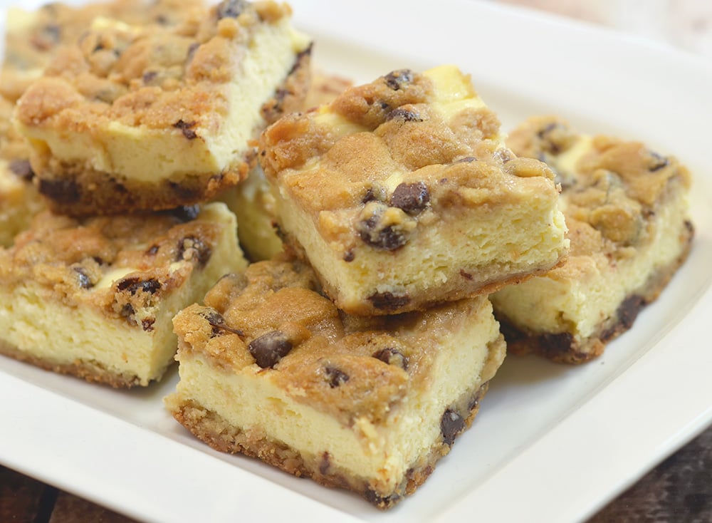 You'll love these chocolate chip cookie cheesecake bars with creamy cheesecake filling sandwiched between chewy chocolate chip cookie layers. They're a delicious marriage of two all time favorites! Chip Cookie Cheesecake bars with creamy cheesecake filling sandwiched between chewy chocolate chip cookie layers.