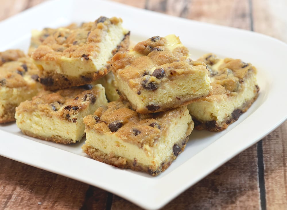 Chocolate Chip Cookie Cheesecake bars with creamy cheesecake filling sandwiched between chewy chocolate chip cookie layers. They're a delicious marriage of two all time favorites!