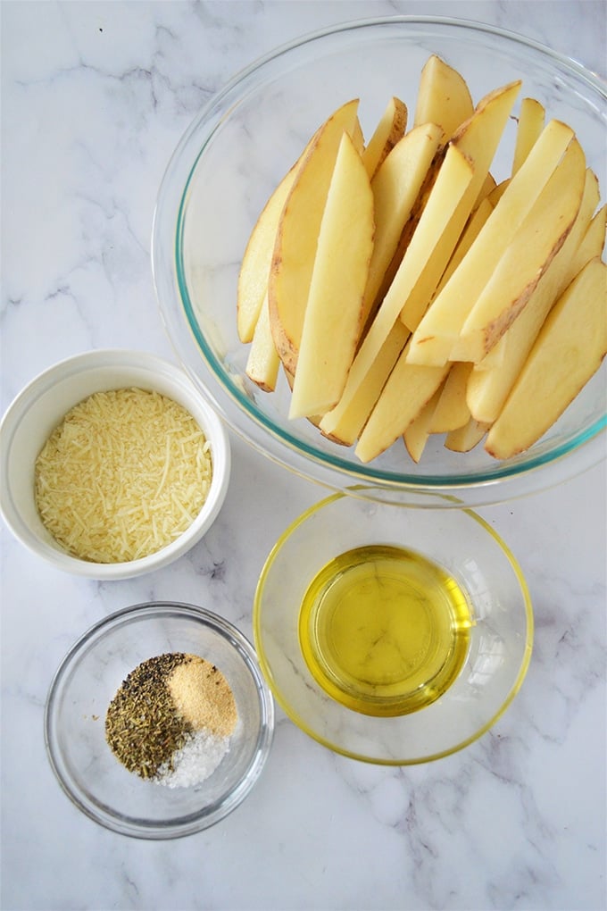 cut-up potatoes in wedges, olive oil, Parmesan cheese, seasonings