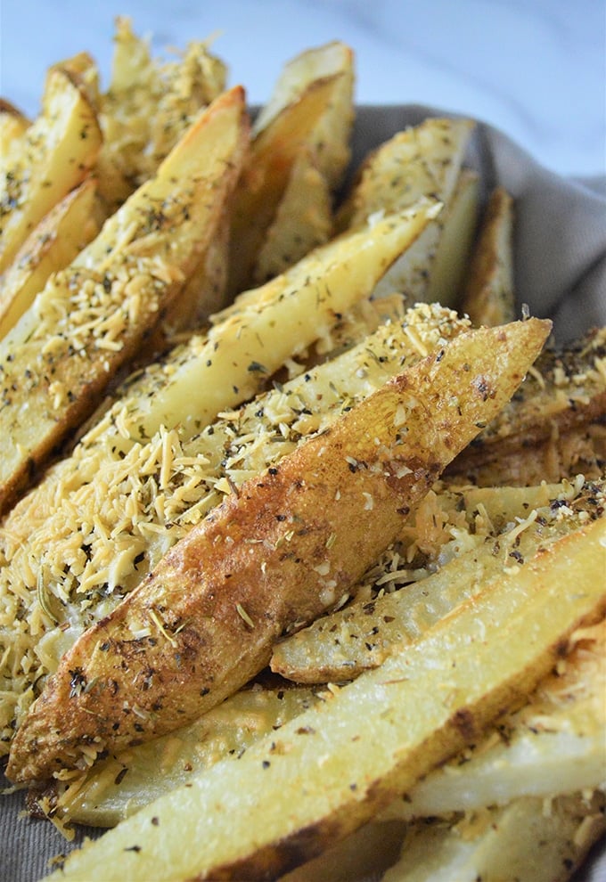 oven-baked potatoes with Parmesan cheese on a white plate