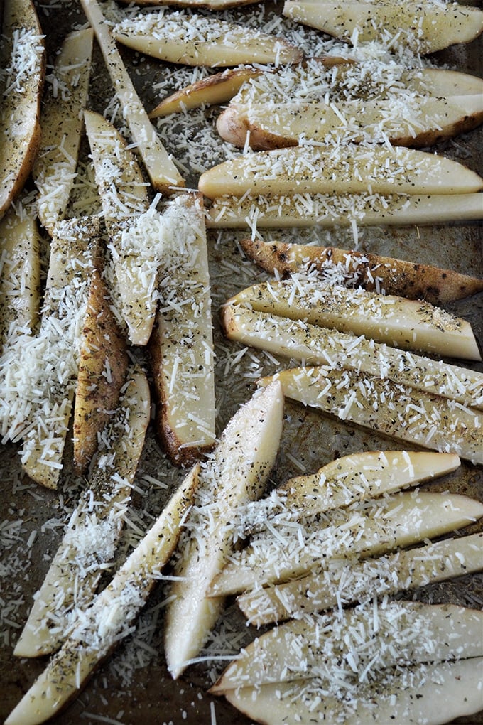 cut-up potatoes on a baking sheet ready to bake 