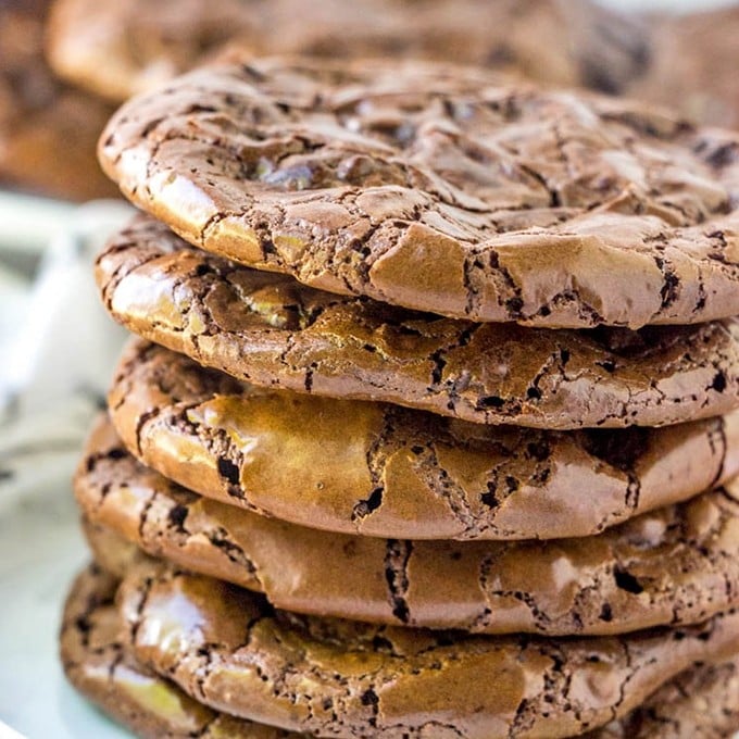 Flourless Chocolate Fudge Crinkle Cookies stacked on on a plate