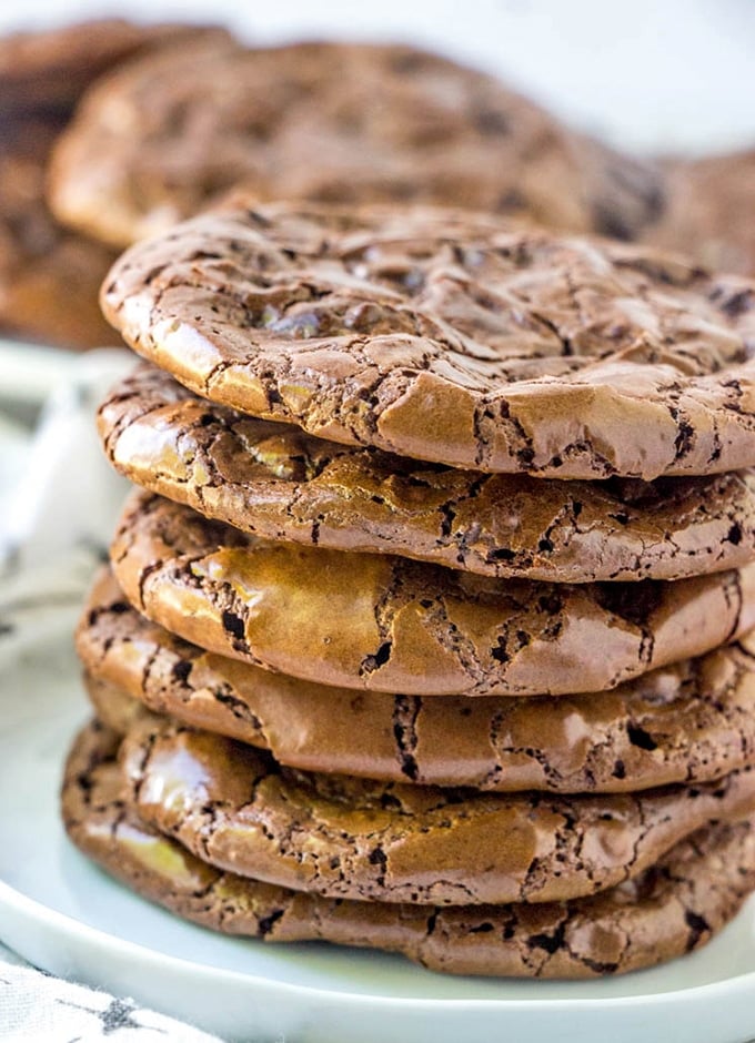 Flourless Chocolate Fudge Crinkle Cookies stacked on on a plate