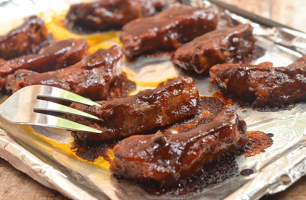 Oven-Baked Baby Back Ribs with Coffee Whiskey Barbecue Sauce are super easy to make yet moist, flavorful and fall-off-the-bone tender. They're finger-licking, lip-smacking amazing!