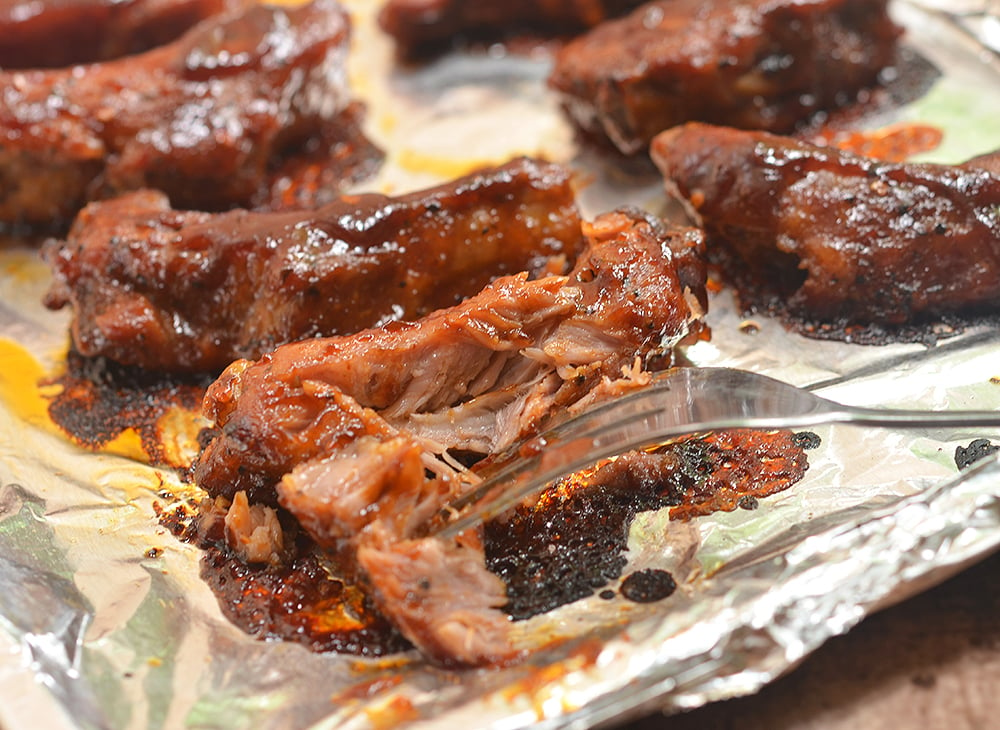 Oven-Baked Baby Back Ribs with Coffee Whiskey Barbecue Sauce are super easy to make yet moist, flavorful and fall-off-the-bone tender. They're finger-licking, lip-smacking amazing!