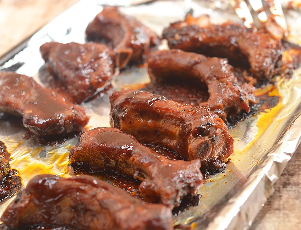 Oven-Baked Baby Back Ribs with Coffee Whiskey Barbecue Sauce are super easy to make yet moist, flavorful and fall-off-the-bone tender. They're finger-licking, lip-smacking amazing!