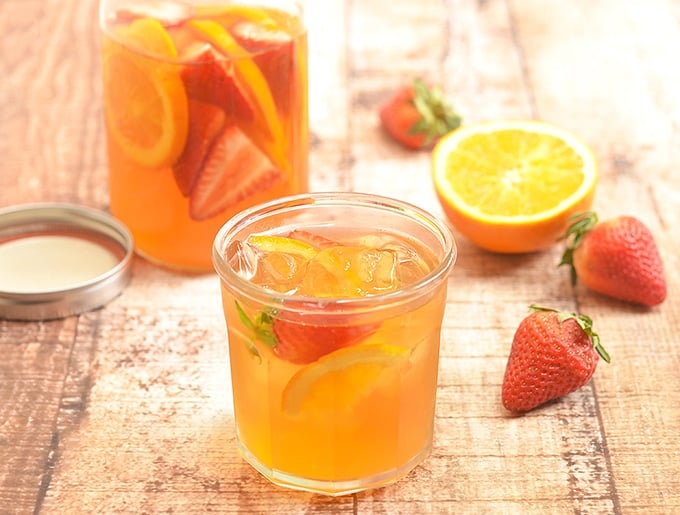 Cold brew iced tea with strawberries and oranges is a sweet and refreshing summer beverage