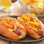 Bacon-Wrapped Hot Dogs are called danger dogs for a reason. Wrapped in smoky bacon and loaded with caramelized onions and peppers, they're dangerously delicious!