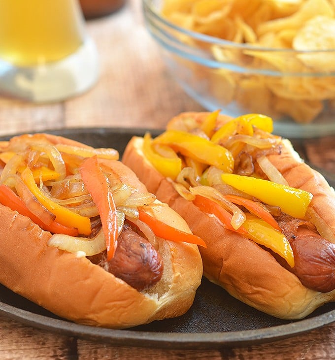 Bacon-Wrapped Hot Dogs are called danger dogs for a reason. Wrapped in smoky bacon and loaded with caramelized onions and peppers, they're dangerously delicious!