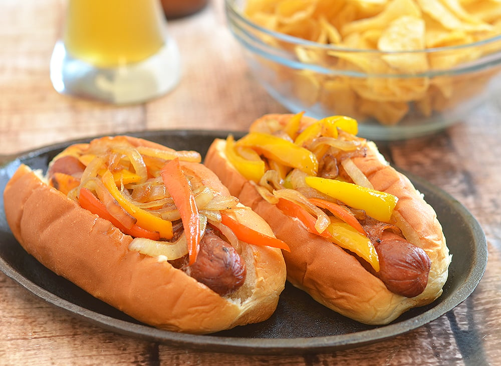 Bacon-Wrapped Hot Dogs are called danger dogs for a reason. Wrapped in smoky bacon and loaded with caramelized onions and peppers, they're dangerously delicious!