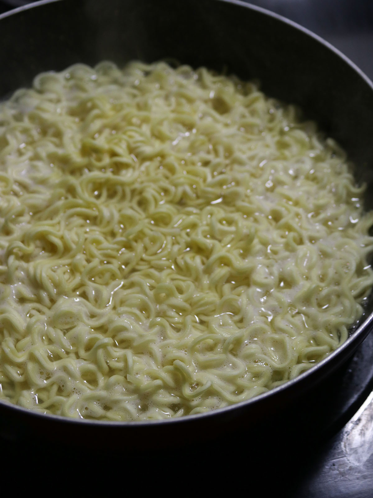 cooking instant ramen noodles in a boiling water in a pot