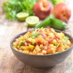 nectarine salsa made with nectarines, lime, cilantro, and jalapenos in a ceramic serving bowl