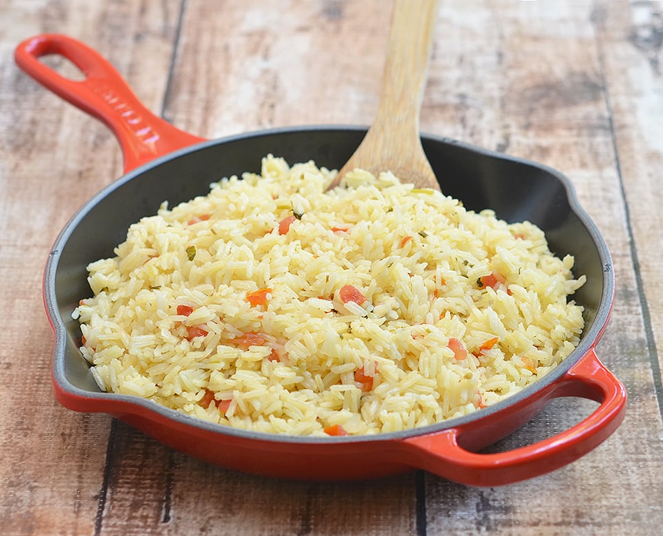 One-pan Spanish rice is seasoned with fresh tomatoes, onions, garlic, cilantro, and lime juice.