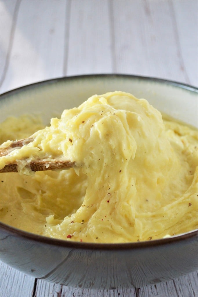 mashed Yukon golds with butter and heavy cream in a large bowl