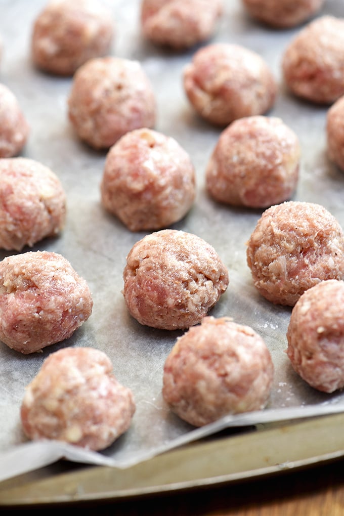 raw meatballs on a baking sheet to freeze