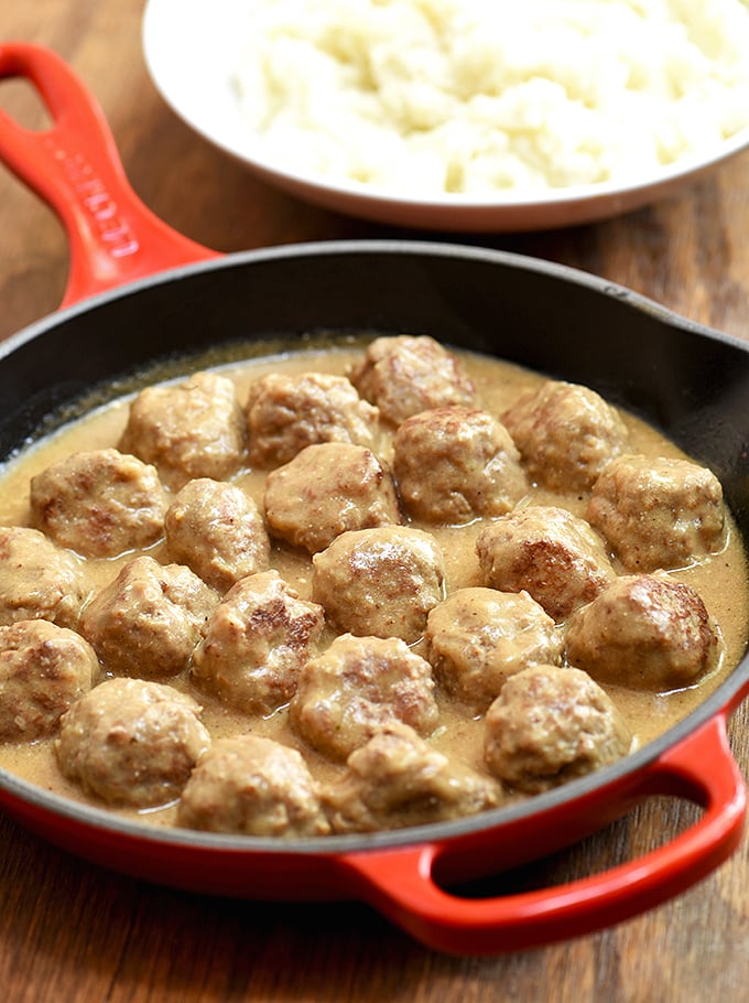 Swedish Meatballs in a skillet with a side of mashed potatoes