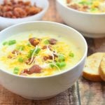 Ultimate Baked Potato Soup loaded with potato chunks, bacon bits, green onions, shredded cheese, and sour cream plus a thick, creamy broth you'd want to dive into! Hearty and delicious, it's the ultimate comfort food!