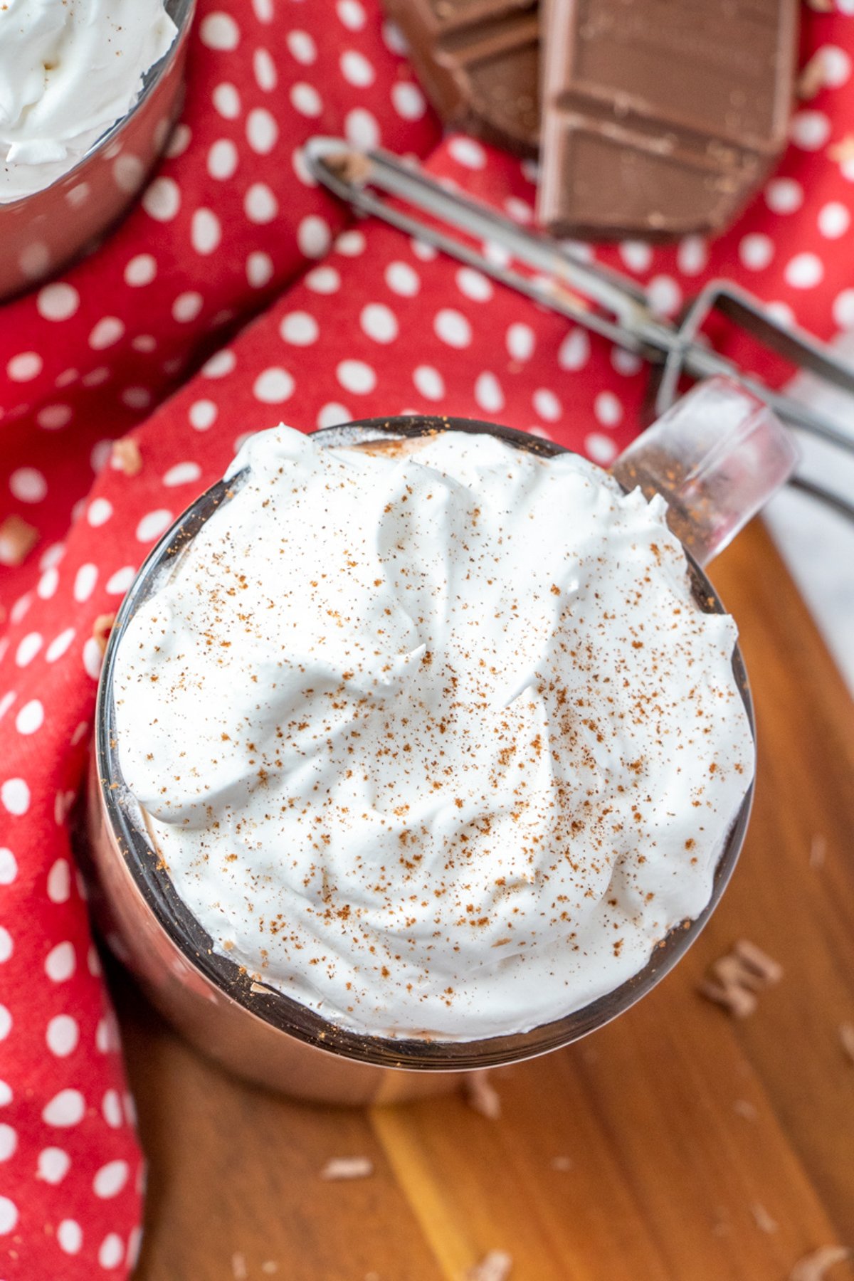 hot chocolate with whipped topping in a glass mug