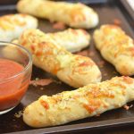 Two-Ingredient Breadsticks with two simple ingredients you probably already have in the kitchen! The versatile two-ingredient dough makes great pizza crust and is perfect for flatbreads, pretzel bites, calzones, and bagels, too!