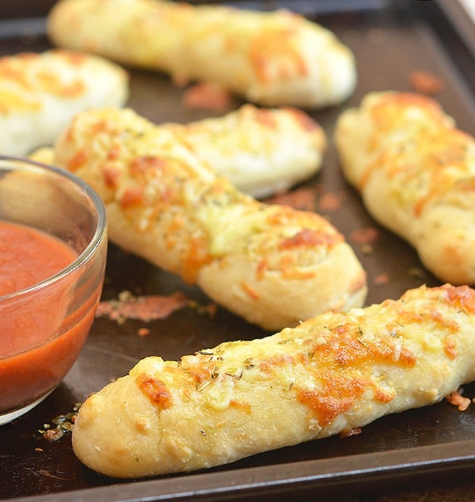 Two-Ingredient Breadsticks with two simple ingredients you probably already have in the kitchen! The versatile two-ingredient dough makes great pizza crust and is perfect for flatbreads, pretzel bites, calzones, and bagels, too!