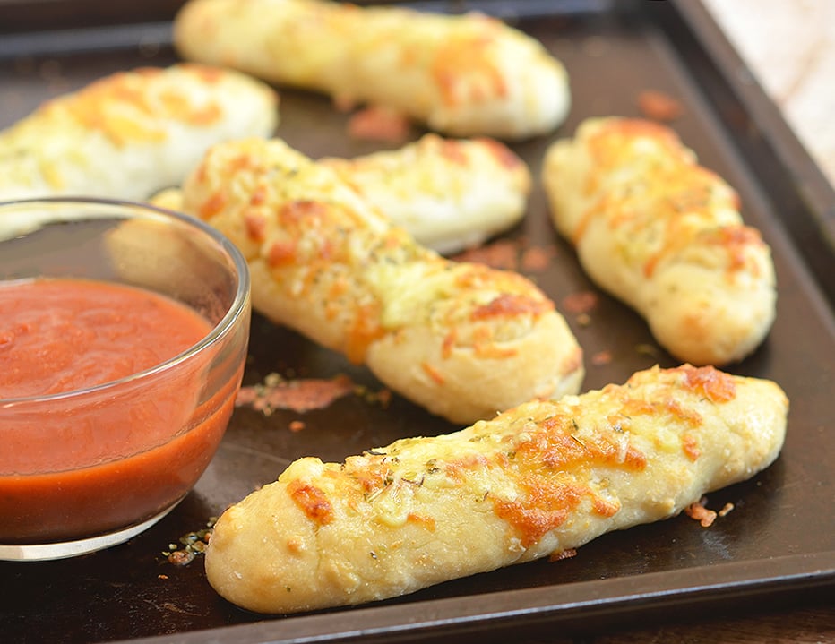 Two-Ingredient Breadsticks with two simple ingredients you probably already have in the kitchen! The versatile two-ingredient dough makes great pizza crust and is perfect for flatbreads, pretzel bites, calzones, and bagels, too!