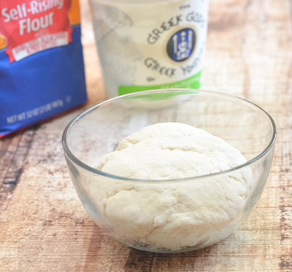 Two-ingredient bread dough in a bowl made with self-rising flour and Greek yogurt